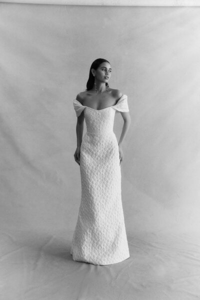 black and white image bride wearing off the shoulder textured wedding dress