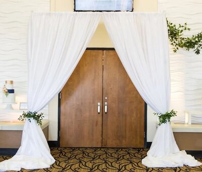 Bliss 2021 Mayborn Center Shelly Taylor Photography White Voile Door Entry with Greenery Tie Backs