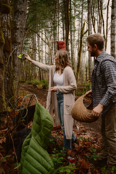 couple-hanging-jackets-forest