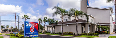 Entry sign for Studio 6 Hotel in McAllen Texas identifying the extended stay hotel supported by WLS Interests operational oversight.