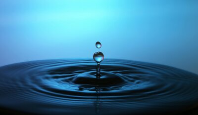 A single droplet of water, symbolizing the gentle and eco-friendly pet aquamation process offered by Nature's Way Pet Aquamation in Lansing, Michigan.