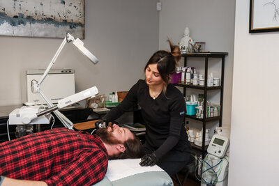 Esthetician giving a men's facial in Albuquerque