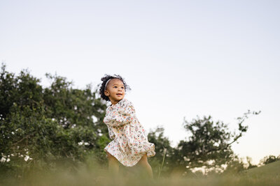 Toddler girl running at Moncus Park