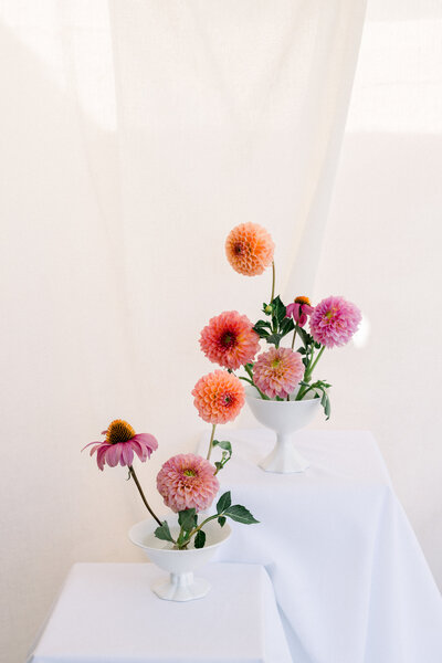 Delicate red tulips designed on a reception table in the heart of Monroe Street Abbey in Phoenix, Arizona by Snapdragon Bloom Bar.