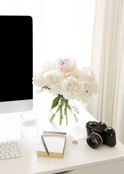 White peony camera desktop flatlay