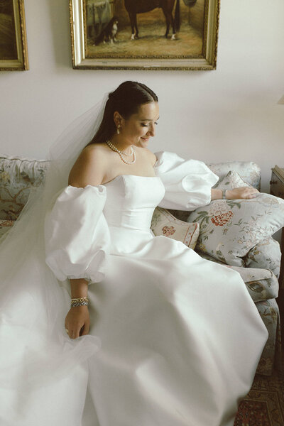 Bride in her wedding dress on the couch