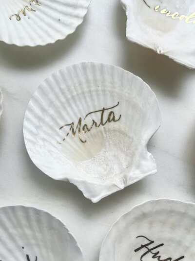 Scallop shell place cards with gold ink calligraphy for wedding in Maui, Hawaii