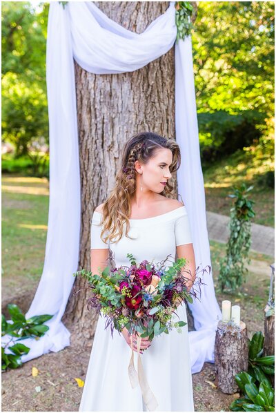 bridal portraits with boho bride hair braided and purple floral bouquet
