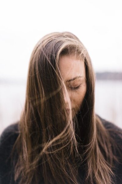 Girl with her hair blowing across her face