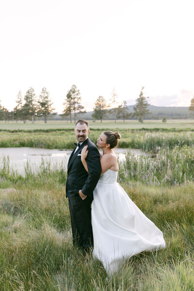 bride and groom holding hands while their bridal party is standing around them