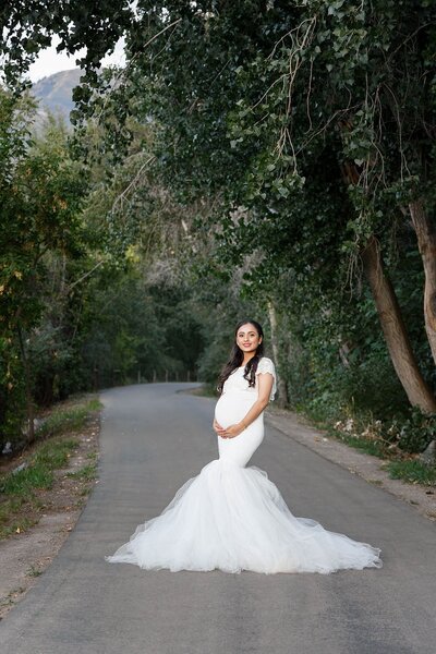 Pregnant mom in a beautiful mint maternity gown.