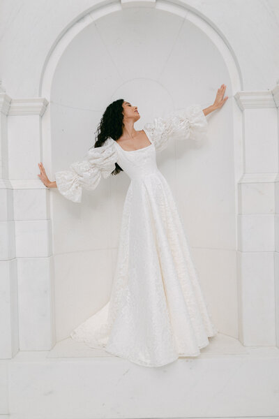black and white image bride wearing  long sleeve lace wedding dress