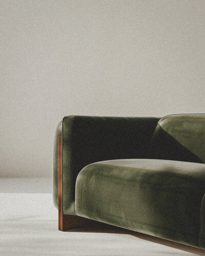 clean modern lines of a loden green velvet sofa in a white room