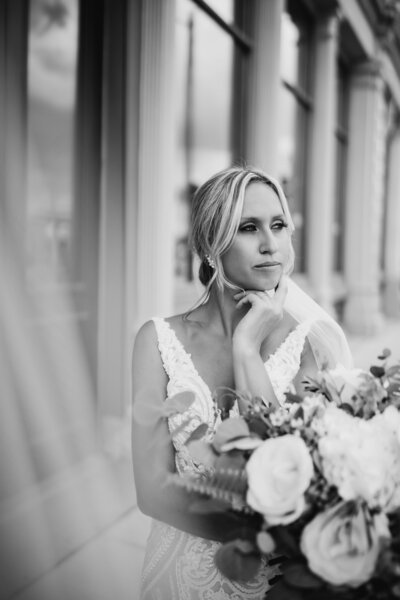 Black and white photo of bride holding flowers