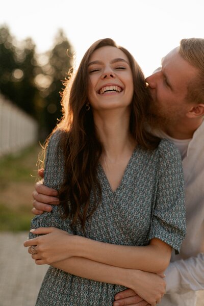 A man embracing his smiling wife. Showing the type of relationship you can have with couples therapy in Manhattan, New York.  Whether you are overcoming an affair or need to improve communication a counselor can help with marriage counseling in Manhattan.