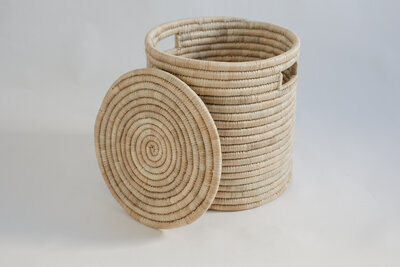 A minimal product photos of woven baskets against a white background. The light is , natural and even. The texture of the baskets stands out