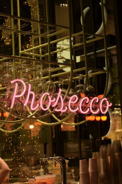 Prosecco written in neon pink writing