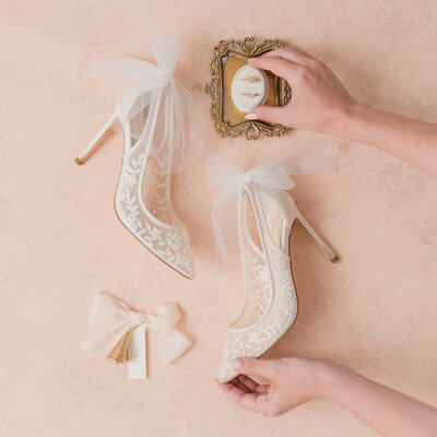 high end fine art luxury styling shot of bridal shoes and details for wedding