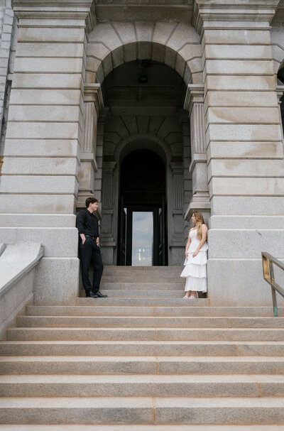 Pueblo couple posing for engagement photos in downtown Denver ahead of their wedding