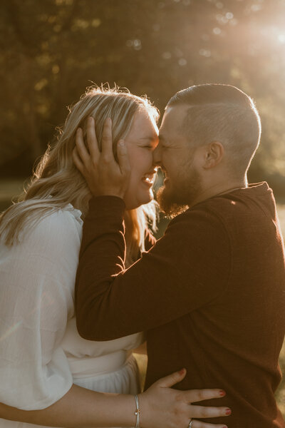 photo of couple nose to nose laughing