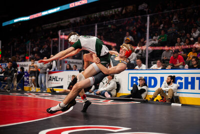 Windsor High School wrestler executing a takedown during a meet in Windsor, Colorado, capturing the intensity and athleticism of high school wrestling.