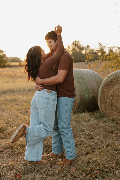 Fall couples session in Aiken SC - holding hands in. a country field with warm golden hour light.