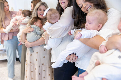 Large group of women holding their babies