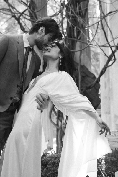 a black and white image of a bride and groom image almost kissing in a garden in montclair new jersey