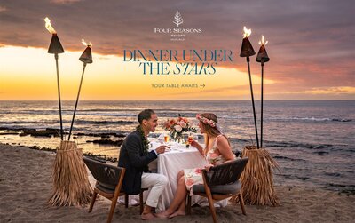 Couple sitting at a private dinner under the stars on the beach at the Four Seasons Hualālai, photographed by Hawaii Adventure Portraits, a Big Island proposal photographer