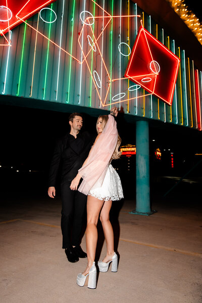 This couple wore Vegas themed attire for their Neon Museum Elopement in Las Vegas