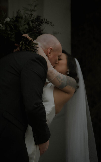 A timeless black and white photo of a couple embracing and sharing a kiss, showcasing their deep love and connection in a classic, romantic style