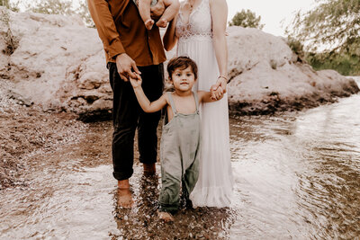 family of 4 playing in river for family photo session in phoenix ariozna