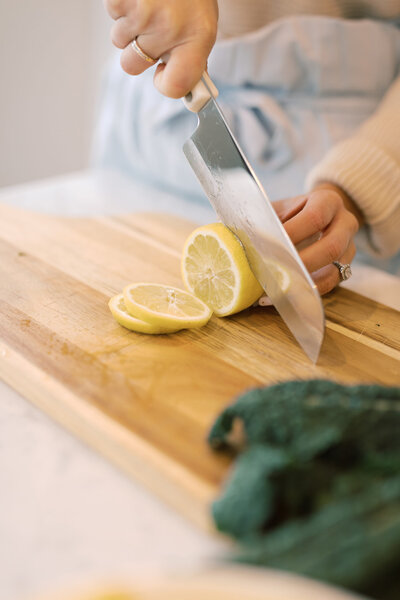 Slicing lemon on a cutting board