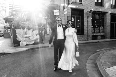 Newlywed couple in sunglasses walking along the streets of Adelaide