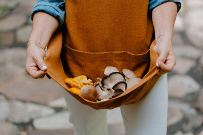 Sam holding an apron full of muchrooms