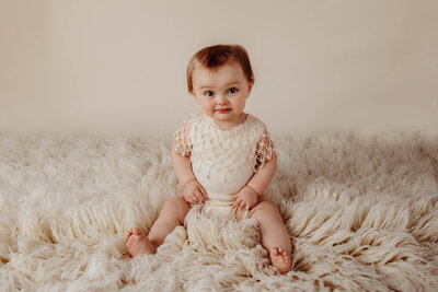 newborn photographer holding camera and smiling in Fargo