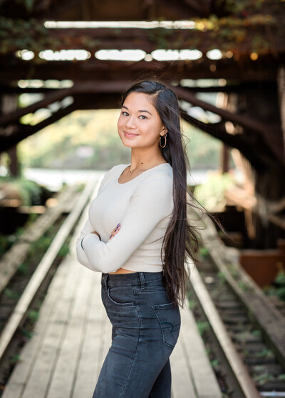 high school senior girl in white shirt posing for senior photos in cleveland ohio
