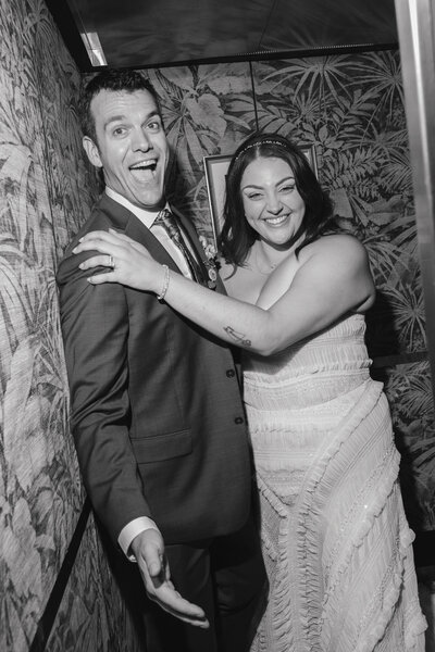editorial photograph of bride and groom laughing in the elevator at The Georgian captured by Los Angeles wedding photographer.