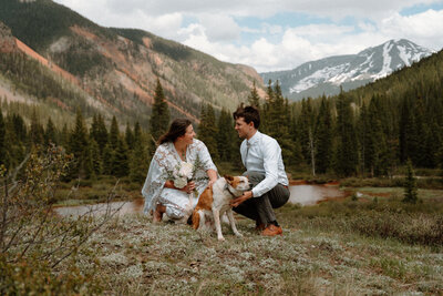 An elopement couple and their dog posing for a photo in the San Juan Mountains of Colorado.
