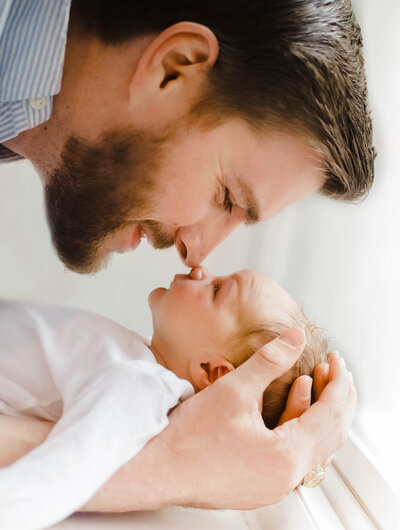 dad and newborn in north carolina in home photoshoot