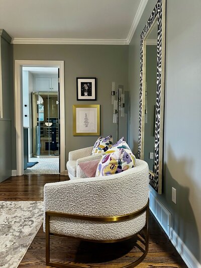 Two textured modern chairs neatly arranged with colorful throw pillows.