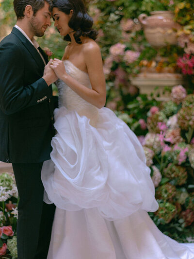 Bride and groon at Gosford Hall in front of flowers 