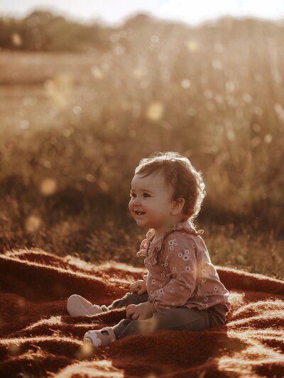 Toddler laughing and smiling during photography session
