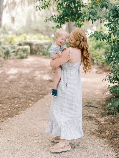 Mom holding toddler boy during family session