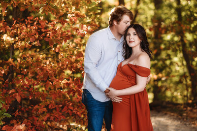 Expectant Parents pose for fall Maternity Portraits in Asheville, NC.