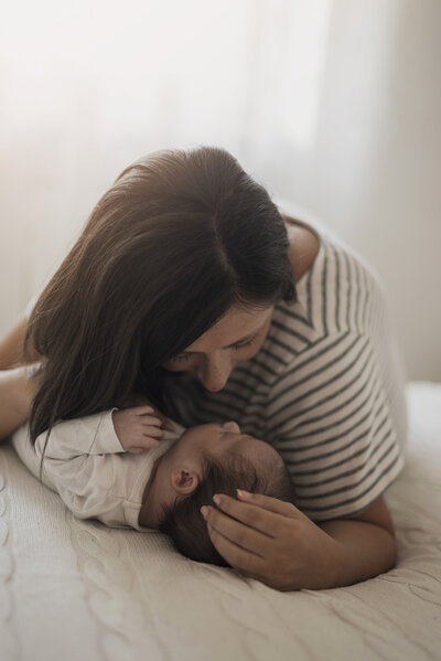Mum and baby cuddle after baby balancing session in Budleigh Salterton.