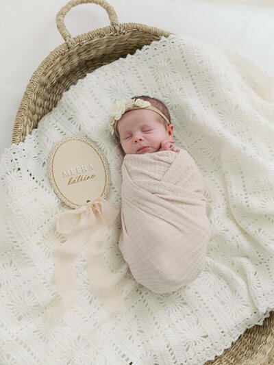 newborn baby sleeps in a basket on a baby blanket all swaddled as photographed by family newborn and maternity photographer Jacqueline Benét 