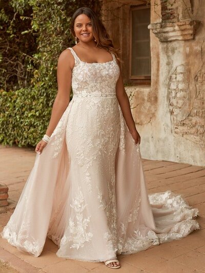Elegant soft Mikado features a contrasting beaded bodice and illusion hemline on this strapless gown.