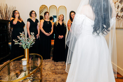 Bride with bridesmaids first look in bridal suite at Snowline Acres in Kalispell, MT