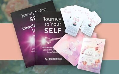 April is presenting an oracle card with her books and card decks beside her